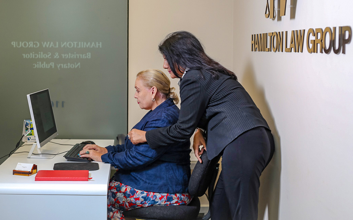 hamilton law front desk Law firm staff assisting a client at the Hamilton Law Group front desk